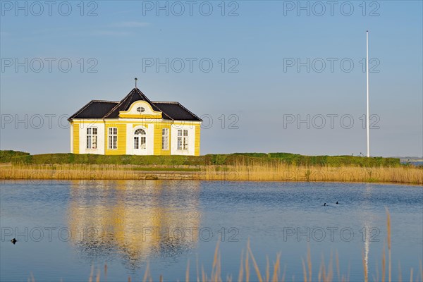 Parts of a castle reflected in a calm pond