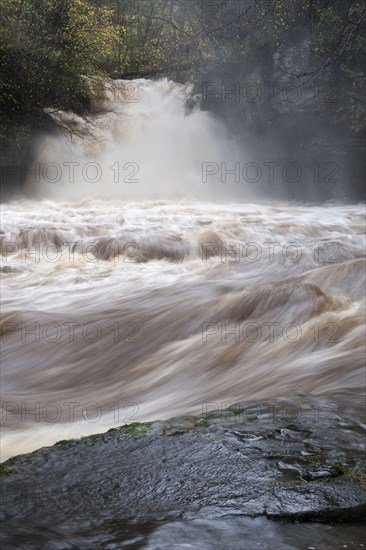 Waterfall and river at flood in full flow