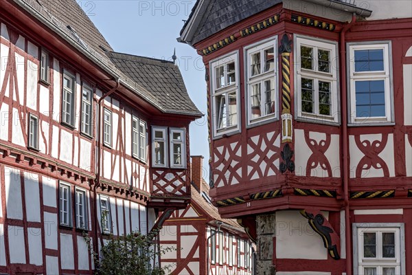 Medieval half-timbered houses with bay windows at the corner of the house