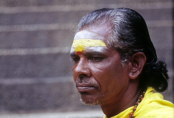 A Sadhu sitting on the steps of Arulmigu Dhandayuthapani Swamy Temple at Palani near Coimbatore