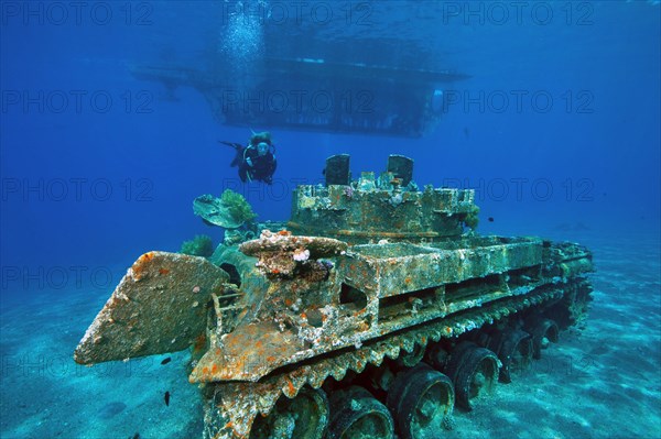 Glass bottom boat and sunken tank at Seven Sisters dive site