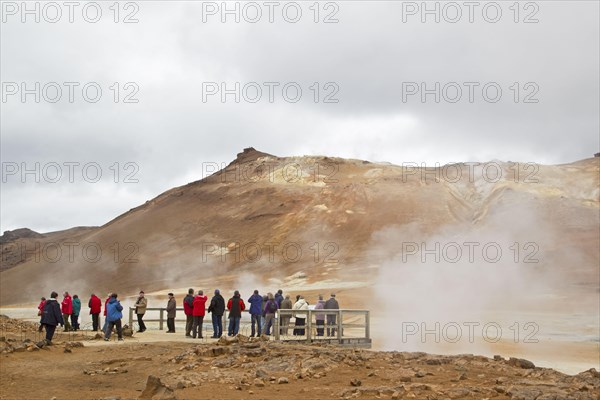 Geothermal activity with tourists on viewing platform