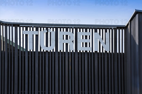 Lettering doors on wooden palisade