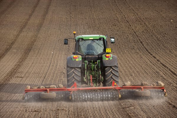 John Deere tractor pulling the soil press