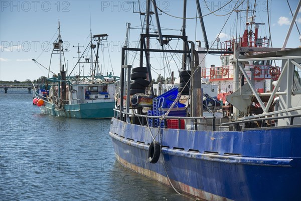 Fishing boats moored at coastal port