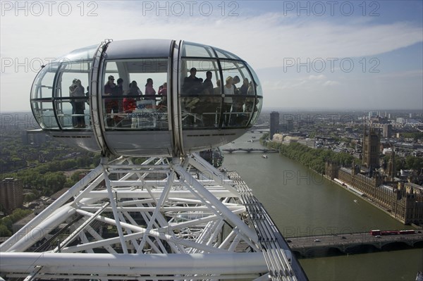 Ferris wheel passenger pods overlooking the city river
