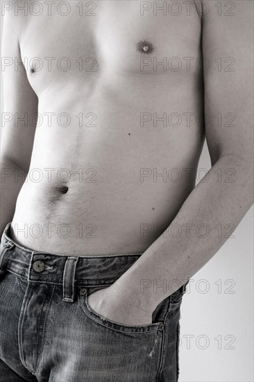 Nude male wearing jeans