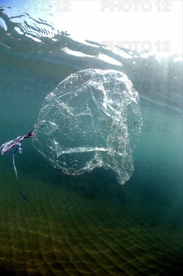 Foil balloon drifting underwater in sea