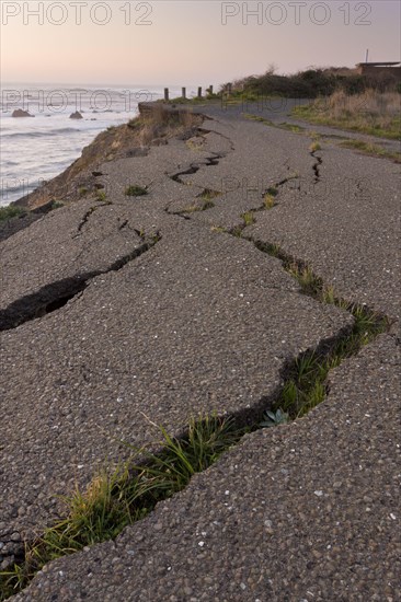 Erosion of sea cliffs with damaged road
