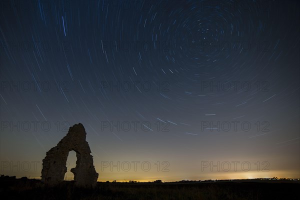 Church ruins and star trails at night