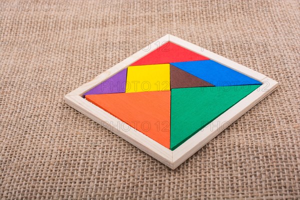 Colorful pieces of a square tangram puzzle