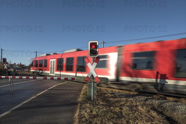 Passing train at a level crossing with barriers
