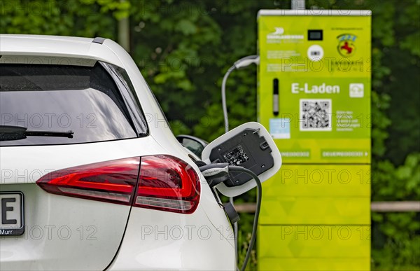 A Mercedes car with electric drive is charged at a charging station in Erding