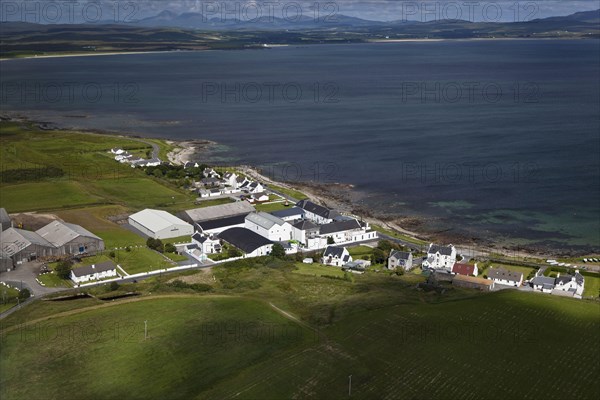 Aerial view of coastline with village and whisky distillery