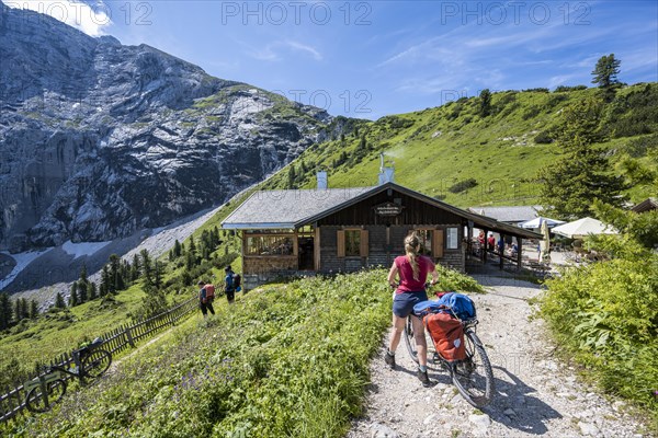 Moutanbikerin at a hut in the mountains