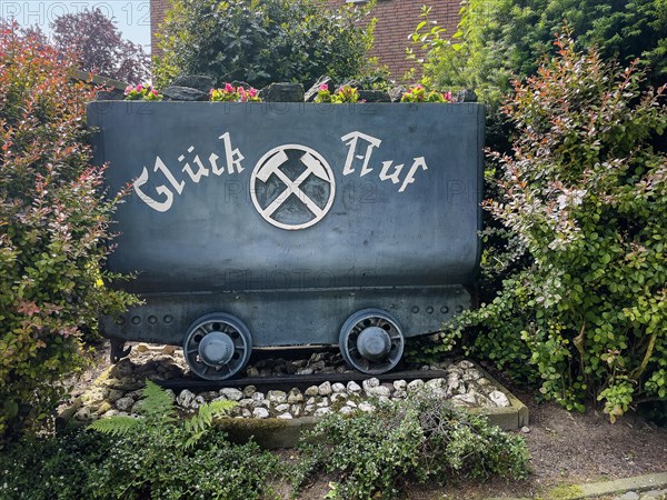 Disused colliery lorry with miner's greeting Glueck Auf stands in front garden in the Ruhr area