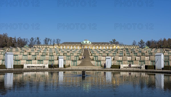 Sanssouci Palace in March with wooden panelling on the figures around the fountain in front of the flight of steps