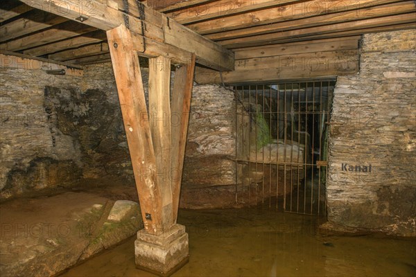View of antker drainage canal in substructure Arenakeller cellar of historic Roman amphitheatre of Trier Treverorum Augusta with supports stamp of wood in groundwater