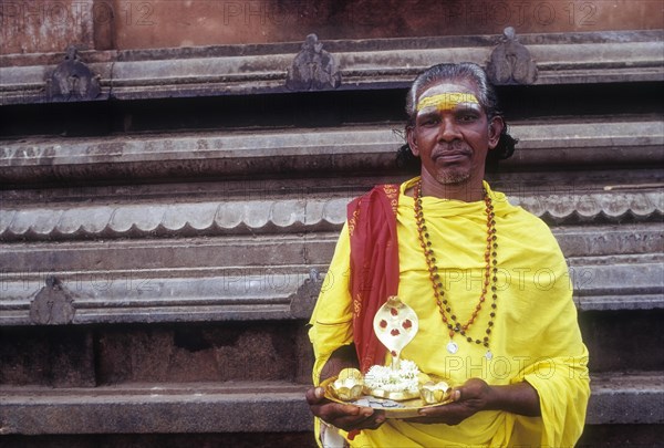 V. Moorthy â€“ Beggar standing with idol naga