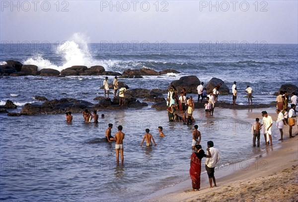 People enjoying in sea water along the shores of the three oceans at kanyakumari