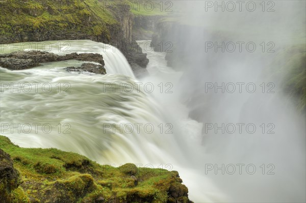 View of river and waterfall flowing into gorge