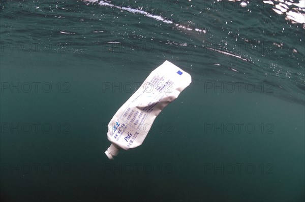 Toothpaste tube floating in sea