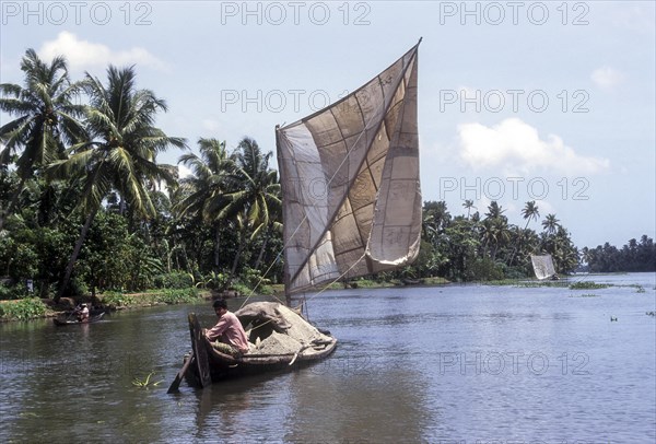 A boat man carrying sand on a dhow
