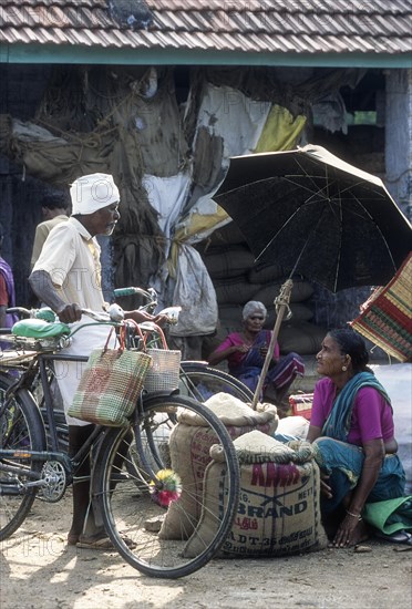 A village woman selling rice in Thudilur periodical market near Coimbatore