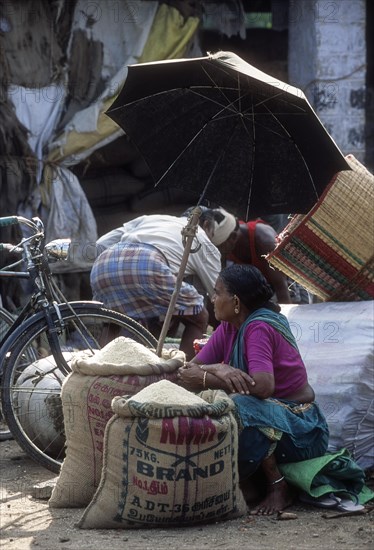 A village woman selling rice in Thudiyalur periodical market near Coimbatore