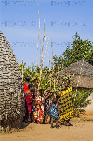 Children watch with interest at traditional customs in real African village