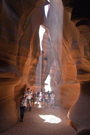 People caught in Light beam in Upper Antelope Canyon was formed by erosion of Navajo Sandstone