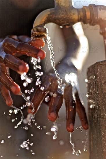 Close-up of hands under tap