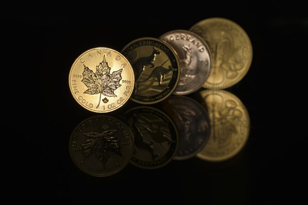 Four mirrored gold coins