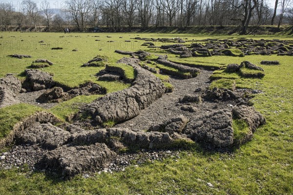 Earthen grassland peeled back by field flooding