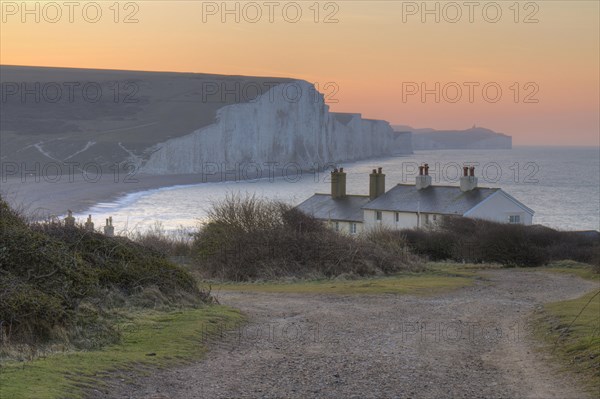 The cliffs and coastguard cottages of the Seven Sisters at dawn. From Seaford Head