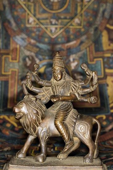 Bronze figure of the Indian goddess Durga riding on a lion figurine