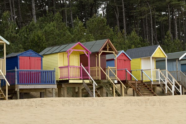 Colourfully painted beach huts at Holkham Bay near Wells by the Sea
