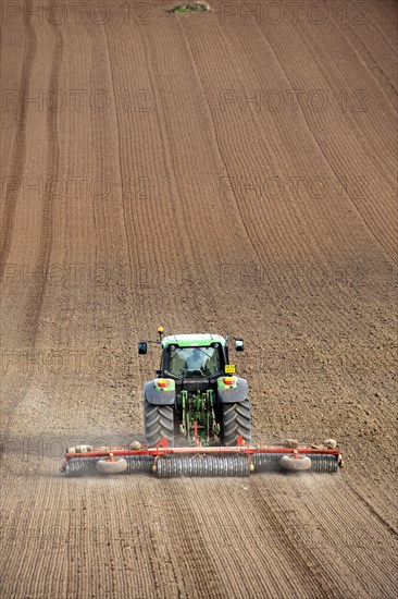 John Deere tractor pulling the soil press