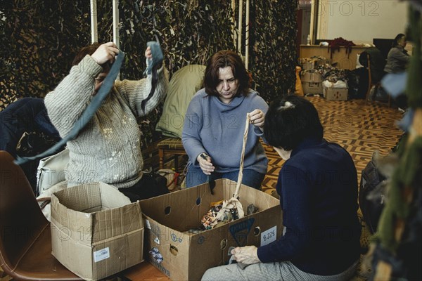 Women and young people knotting camouflage nets in the Youth and Children's Library