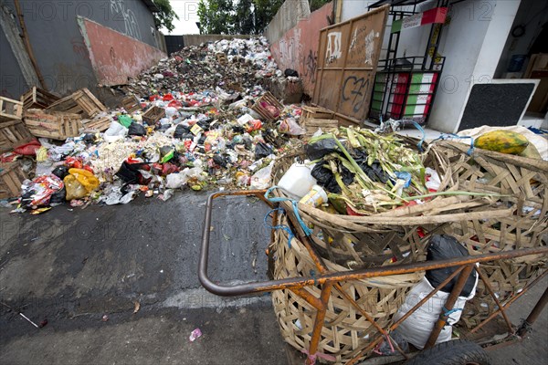 Large pile of rubbish and collection bins in the city