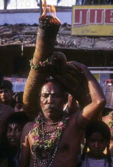 Devotee fulfilling vow during Karamadai chariot festival near Coimbatore