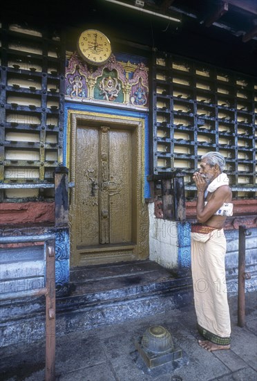 A devotee worshipping lord Sri Krishna after closing the door in Ambalapuzha