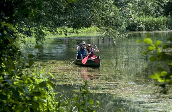 Canoeists paddling on river