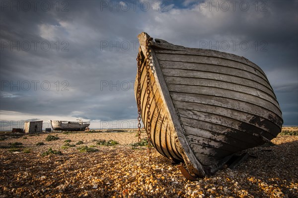 Abandoned fishing boats on a shingle beach