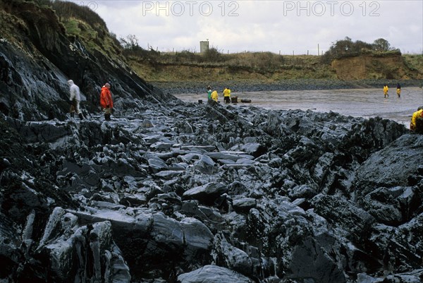 Clean-up operation on oil-covered rocky coast after Sea Empress disaster