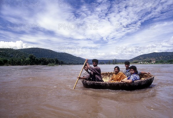 Tourists enjoying coracle ride in River Cauvery