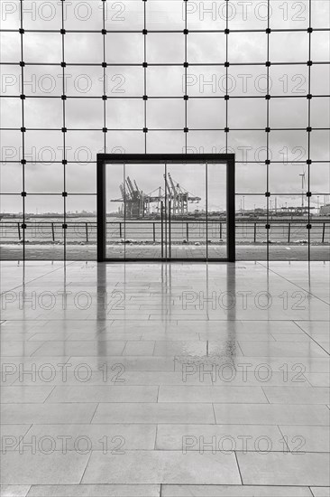 View through modern glass facade with large door onto the harbour