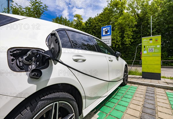 A Mercedes car with electric drive is charged at a charging station in Erding