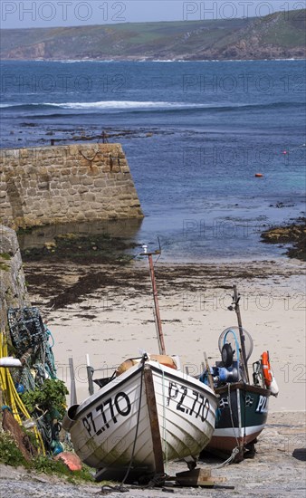 Fishing boats moored in the harbour of a coastal village