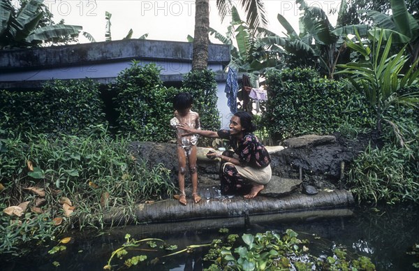 A Woman Bathing her daughter